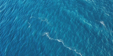 aerial view of turquoise ocean waves with white foam patterns near coastline © Nasrin