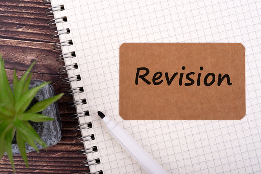 Brown memo pad with text Revision