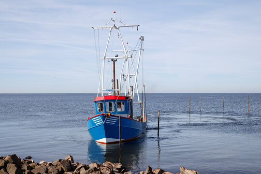 Fishing boat setting traps on IJsselmeer lake