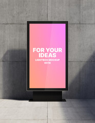 A 9x16 vertical lightbox stands on a metal support against a concrete wall for presenting your ideas. Presentation space. Advertising space. 3D rendering © Vladislav