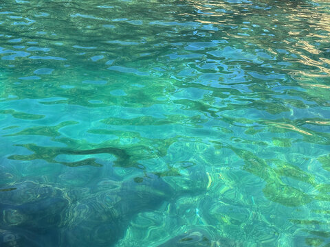 Transparent sea emerald green clear water surface.