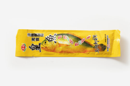 Moscow Russia 22.08.2025 Packaged dried fish snack with Chinese text and whole fish illustration isolated on white background. Traditional spicy seafood snack, retail packaging and Asian convenience f