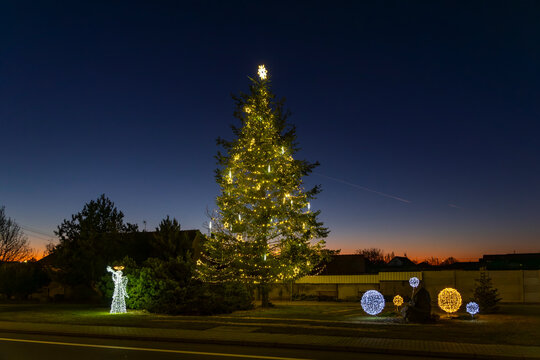 Christmas tree and festive decorations lighting up Chvalovice at dusk