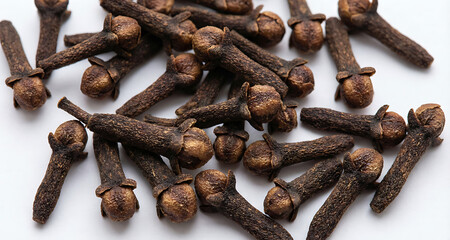 Fototapeta premium Whole Cloves Spices Scattered on White Background