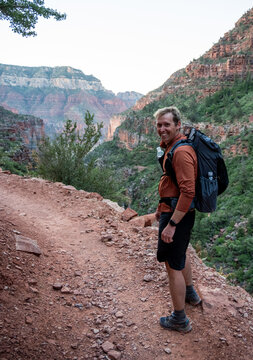 Hiker Looks Back At Camera Along North Kaibab Trail In The Moning