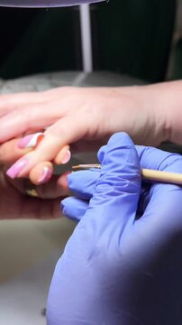 Beauty salon manicure with gel polish application and nail filing