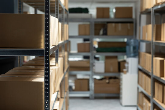 Empty factory warehouse with pallets and organized shelves with boxes. Logistics center serves supply chain, designed for distribution, manufacturing and import export operations.