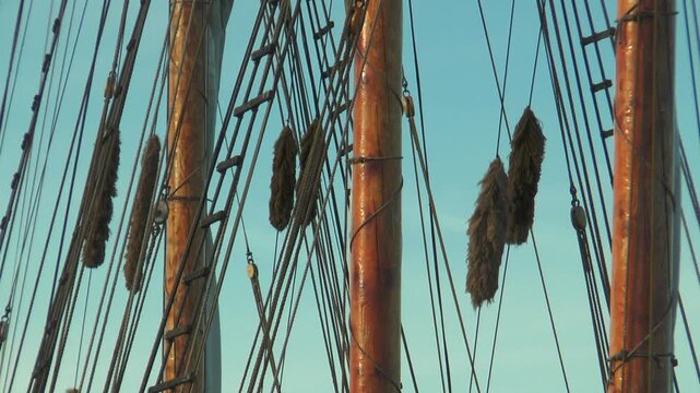 Helsinki, Finland. Masts and rigging of a sailing ship against a blue sky. Warm summer evening.