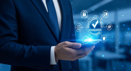 Fototapeta premium businessman presenting digital standards and quality management system on smartphone symbolizing corporate compliance and data security.