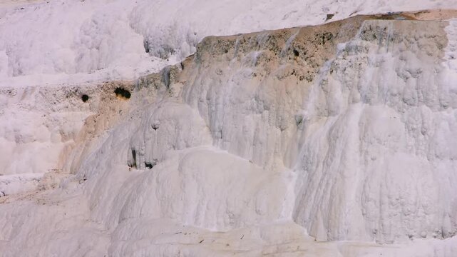 Footage of the stunning natural landscape of Pamukkale, a UNESCO World Heritage site in Denizli Province, Turkey. The video captures the unique white calcium carbonate terraces, formed by mineral-rich