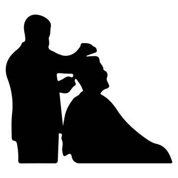 Silhouette of a Barber Cutting Hair of a Client in a Salon.