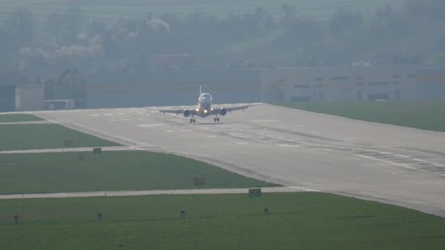 Passenger aircraft gracefully lands at bustling airport, marking a fulfilling journey and arrival at a travel destination