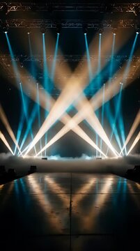 Bright stage lights creating intersecting beams in a dark concert venue.