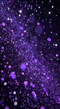 Abstract purple and white bokeh light particles on dark background.