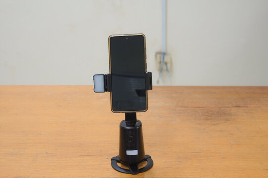 Smartphone on an automatic tracking stand for video recording