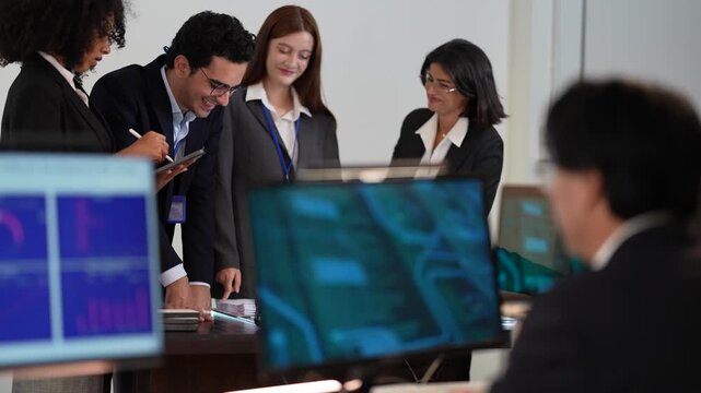 International multicultural experts showing professional colleagues from varied backgrounds managing digital safeguard protocols and network security within a state of the art command center.