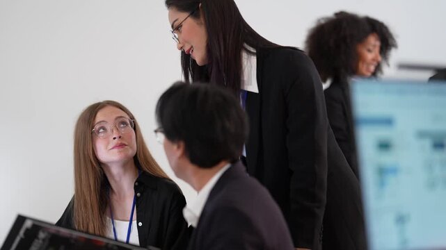 Poised cross functional specialists with diverse ethnic team members managing digital safeguard protocols and network security at a high tech operations center at night.