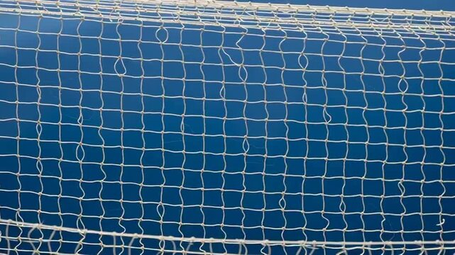 close-up of white fishing net against blue water