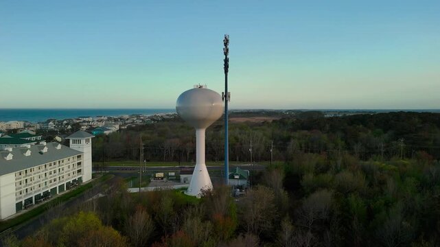 Aerial view of water tower and coastal resort at sunset in Sandbridge Virginia Beach