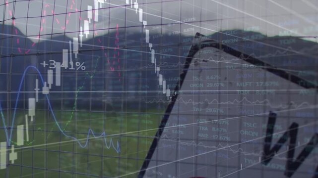 Camera panning from close WIND sign, financial chart fading in, rising, tracking wind farm rally