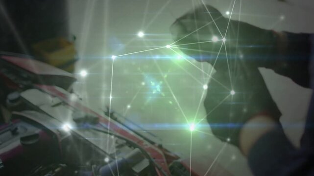 Mechanic appearing leaning probing removing oily cloth lifting inspecting while overlay flashing