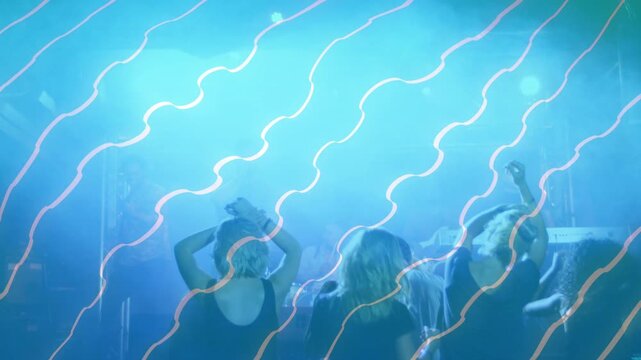 Stage lights kicking off, front-row crowd raising arms and swaying under blue haze for band