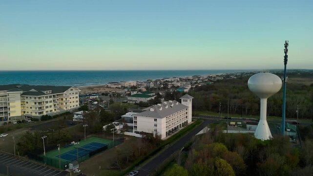 Aerial view of water tower and coastal resort at sunset in Sandbridge Virginia Beach