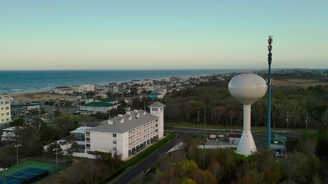 Aerial view of water tower and coastal resort at sunset in Sandbridge Virginia Beach