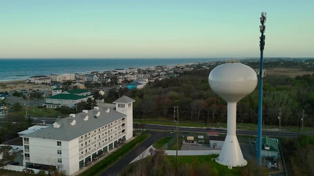 Aerial view of water tower and coastal resort at sunset in Sandbridge Virginia Beach