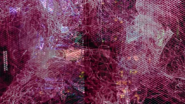 Magenta filaments emerging from left, spreading across metal mesh, showing LED circuitry technology