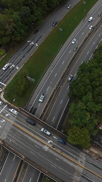 Vertical screen Aerial Highway With Steady Traffic Tennessee Arterial Road Seen From Drone, Multilane Overpass, Vehicles And Trucks Flowing Along Median Corridor, Delivery Drivers