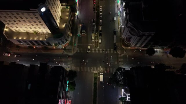 Nighttime Street With Tranquil Ambiance. Silent Can Tho Street Shimmering Under Night Light. Serene Evening Atmosphere On Can Tho Avenue With Gentle Traffic And Glowing Shop Windows