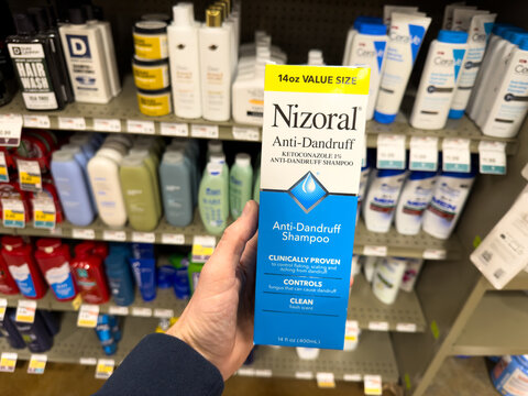 Nizoral Anti Dandruff Shampoo Box Held in Department Store Aisle