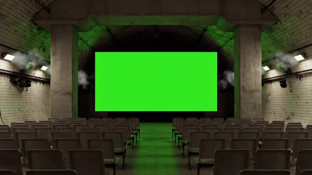 Theater interior with empty seats faces green screen display