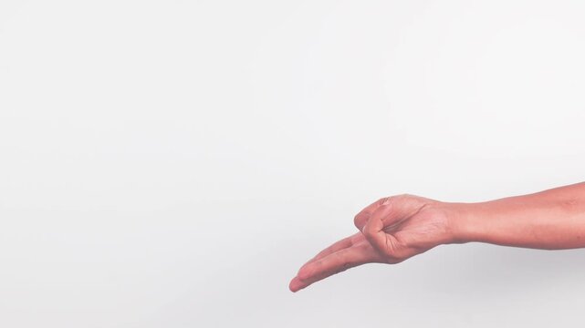 A male, dark-skinned hand with the index and middle fingers extended downward and together, and the thumb holding the ring and pinky fingers, making a gesture, isolated on white background.