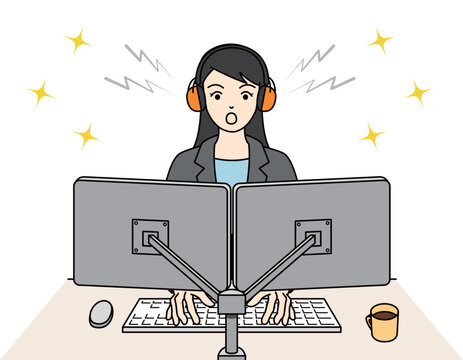 イヤーマフを装着してPC作業に集中する女性