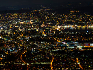 Obraz premium Zurich City Core At Night Vibrant Neighborhoods And Commerce