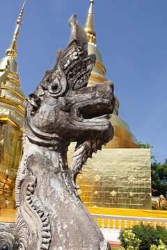 Naga Guardian Statue with Golden Chedi in the background