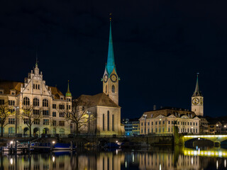 Fototapeta premium Quiet River Reflecting Sparkling City Lights And Historic Architecture