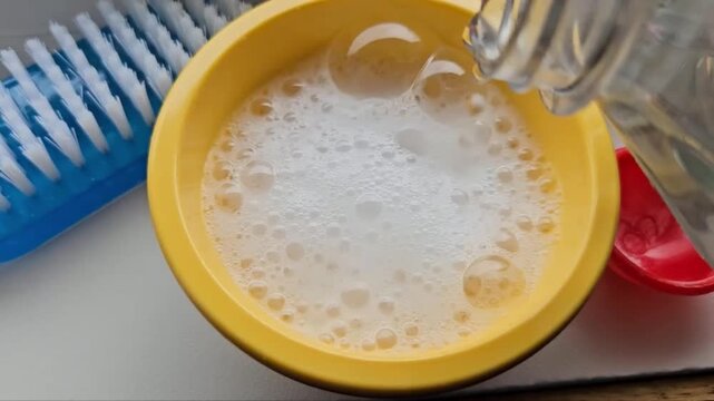 baking soda mixed with vinegar chemical reaction. small bowl. cleaning concepts.