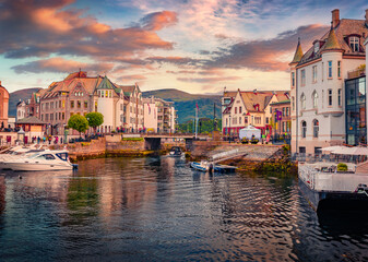 Spectacular summer sunset on Alesund port, town on the west coast of Norway, at the entrance to the Geirangerfjord. Wonderful morning cityscape. Traveling concept background.
