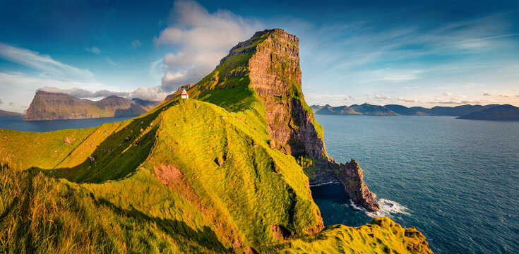 Panoramic morning view of Kallur Lighthouse. Sunny outdoor scene of Kalsoy island. Majestic summer landscape of Faroe Islands, Denmark, Europe. Fantastic seascape of Atlantic ocean. 