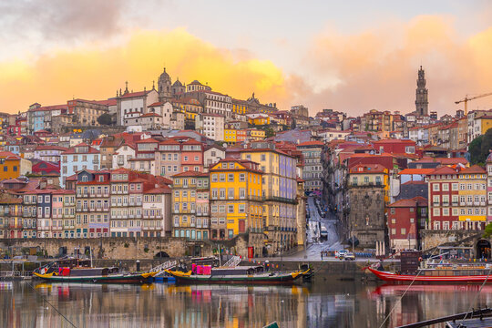 View of Porto's Ribeira district and traditional Rabelo boats on Douro River at sunset