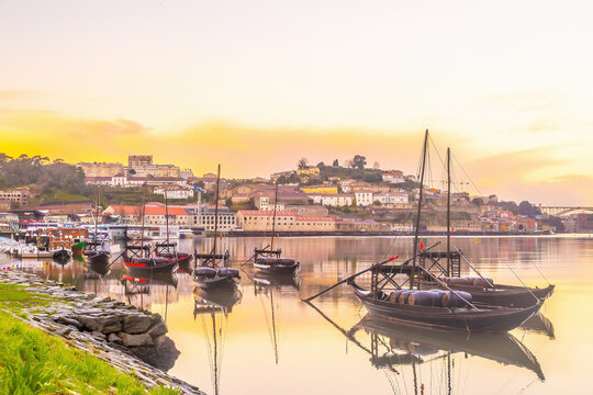 View of Porto's Ribeira district and traditional Rabelo boats on Douro River at sunset