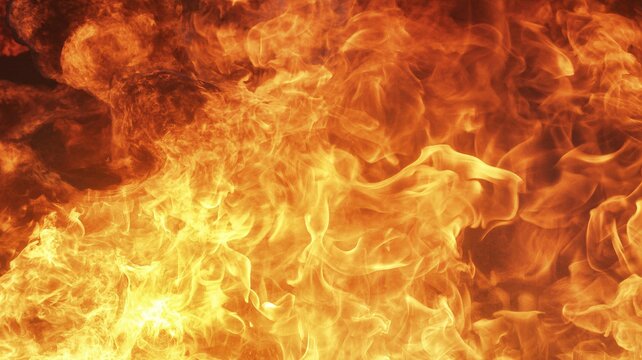 Vibrant yellow and orange flames create a fiery background with intense heat and light