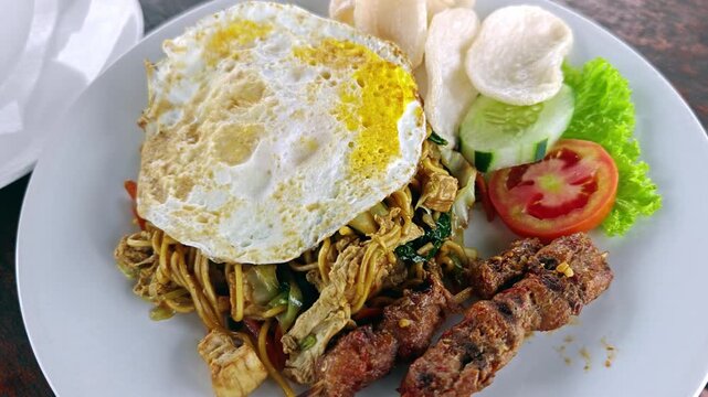 Indonesian Mie Goreng Fried Noodles with Satay Fried Egg and Crackers
