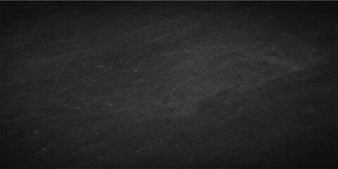 A blank blackboard with a dark grunge texture on a rough vintage surface creates a black chalk board backdrop featuring a gray pattern of old concrete and dirty fabric material © Faysal