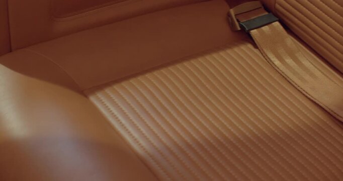 Leather seat detail. Jet seat with textured leather and ribbed finished stitching. Premium textured leather seat panel featuring detailed stitch work and buckle accents