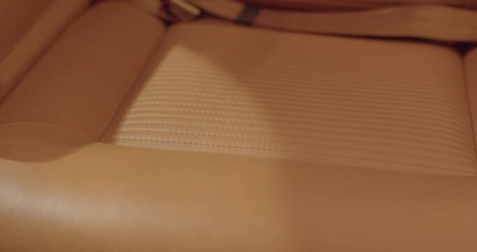 Leather seat closeup. Detail of premium aircraft seat. Close view of jet aircraft leather seat. Zoomedin image showing aircraft leather seat stitching and controls