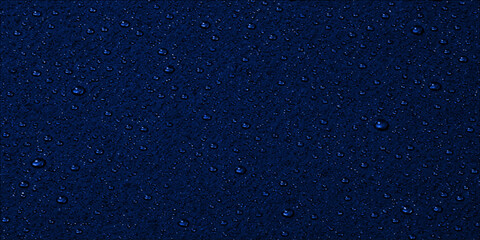 A textured pattern of water drops on a black glass background creates an abstract starry night sky resembling a dark cosmic galaxy of dust and light © Faysal